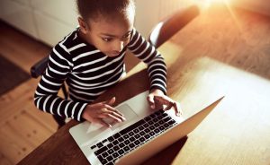 Child using a laptop for e-learning