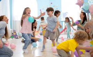 Children and adults playing together indoors.
