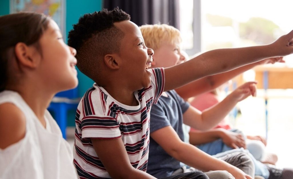 A group of excited children pointing.