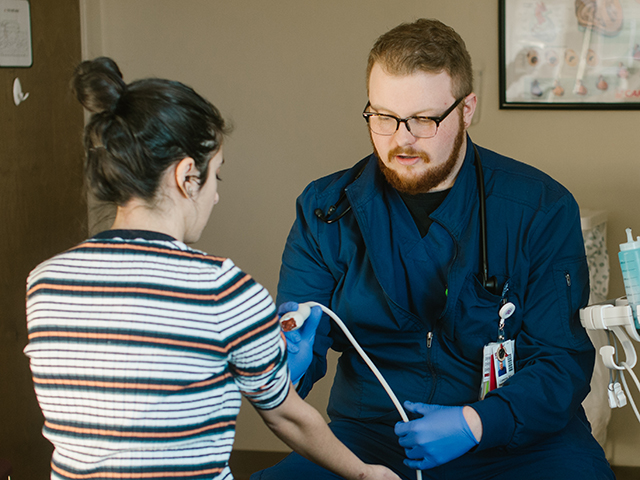 Male nurse working with female patient