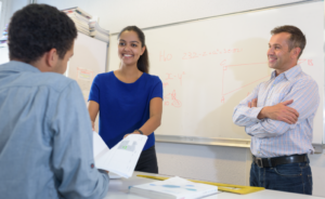 Teacher training a student teacher in the classroom.