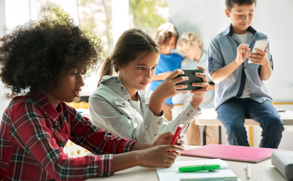 Young students using digital devices at school