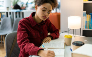 Female student reading and taking notes