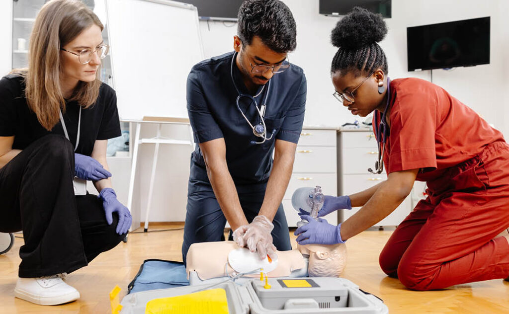 Image of nursing educators teaching nurses how to conduct CPR